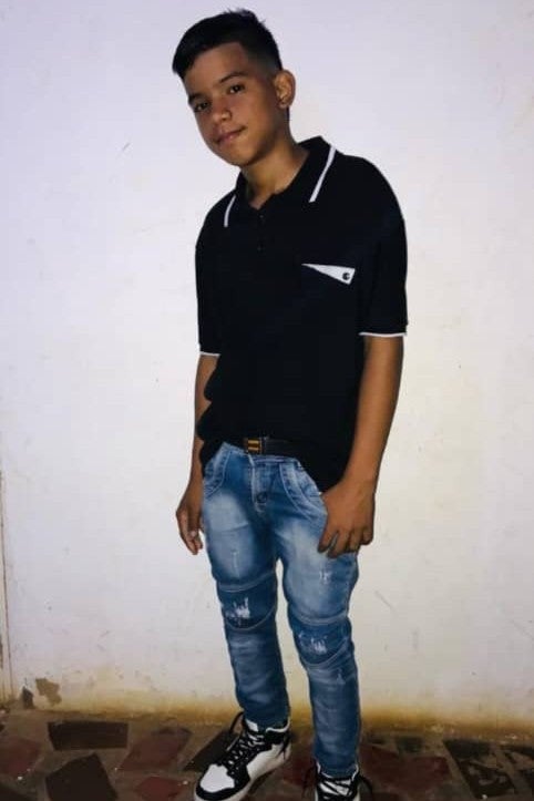 A teenage boy poses for a photo