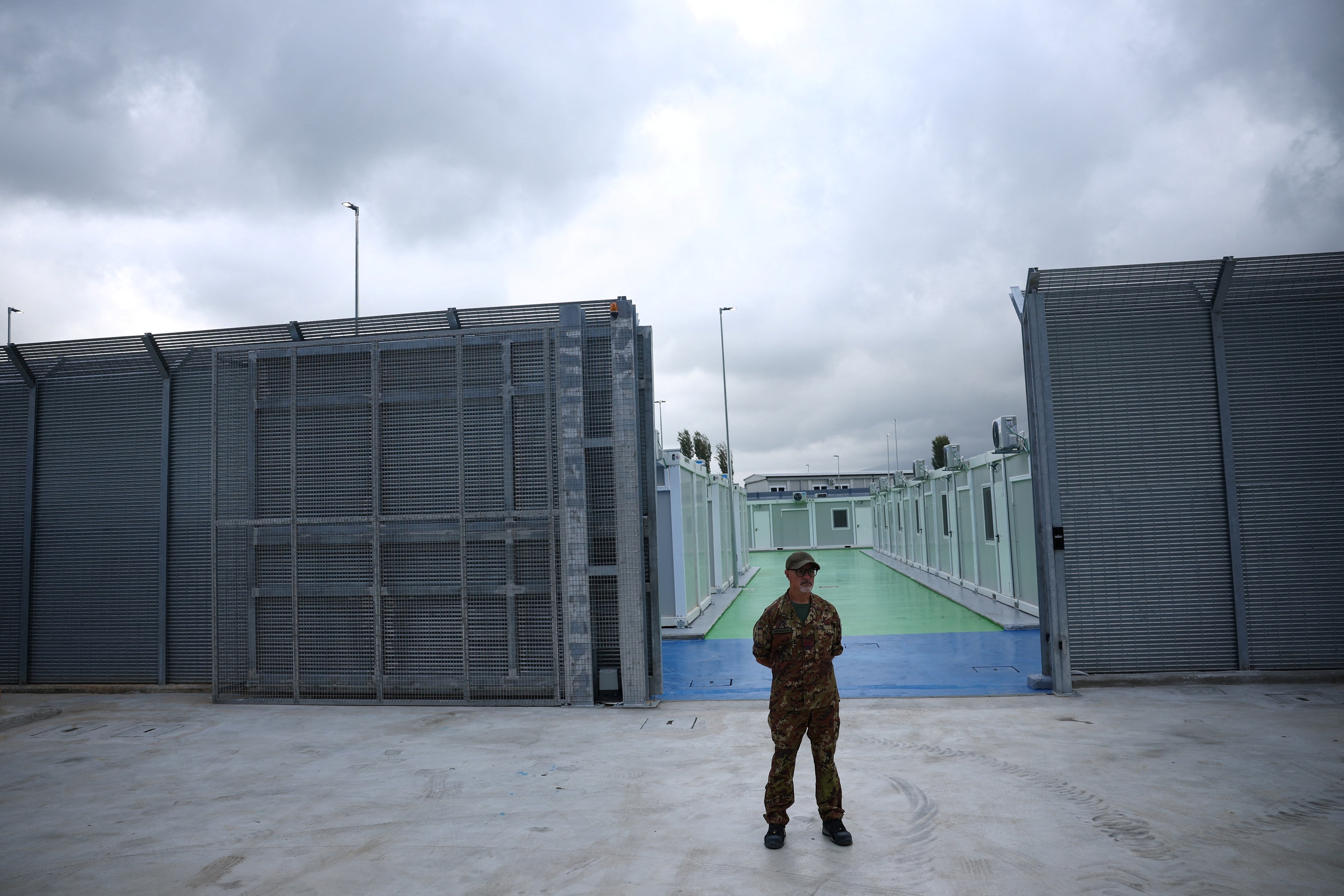 A member of the Italian Army stands in front of an immigration detention camp built by Italy in Gjader, Albania, October 11, 2024. 