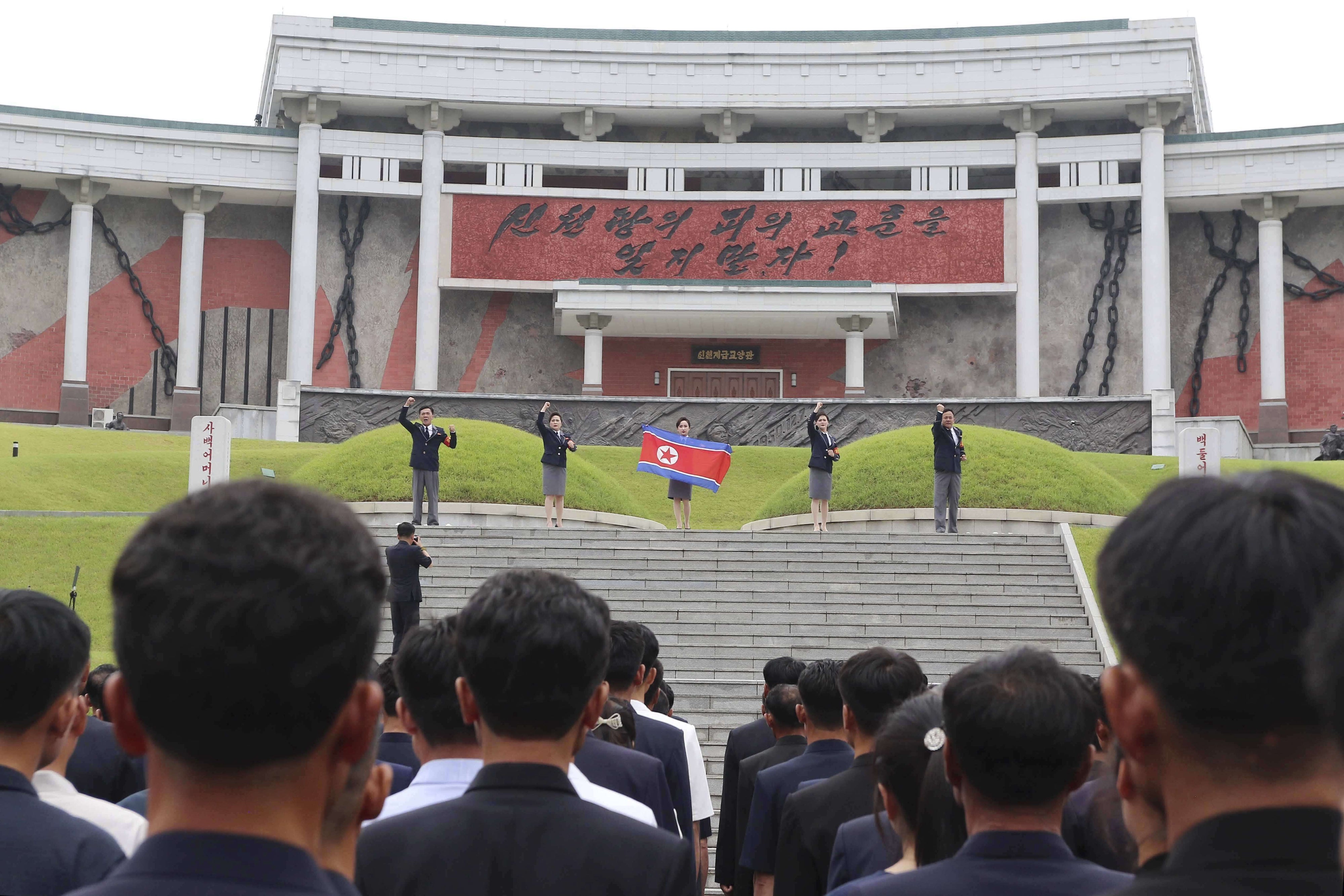 People in North Korea participate in a mass rally.