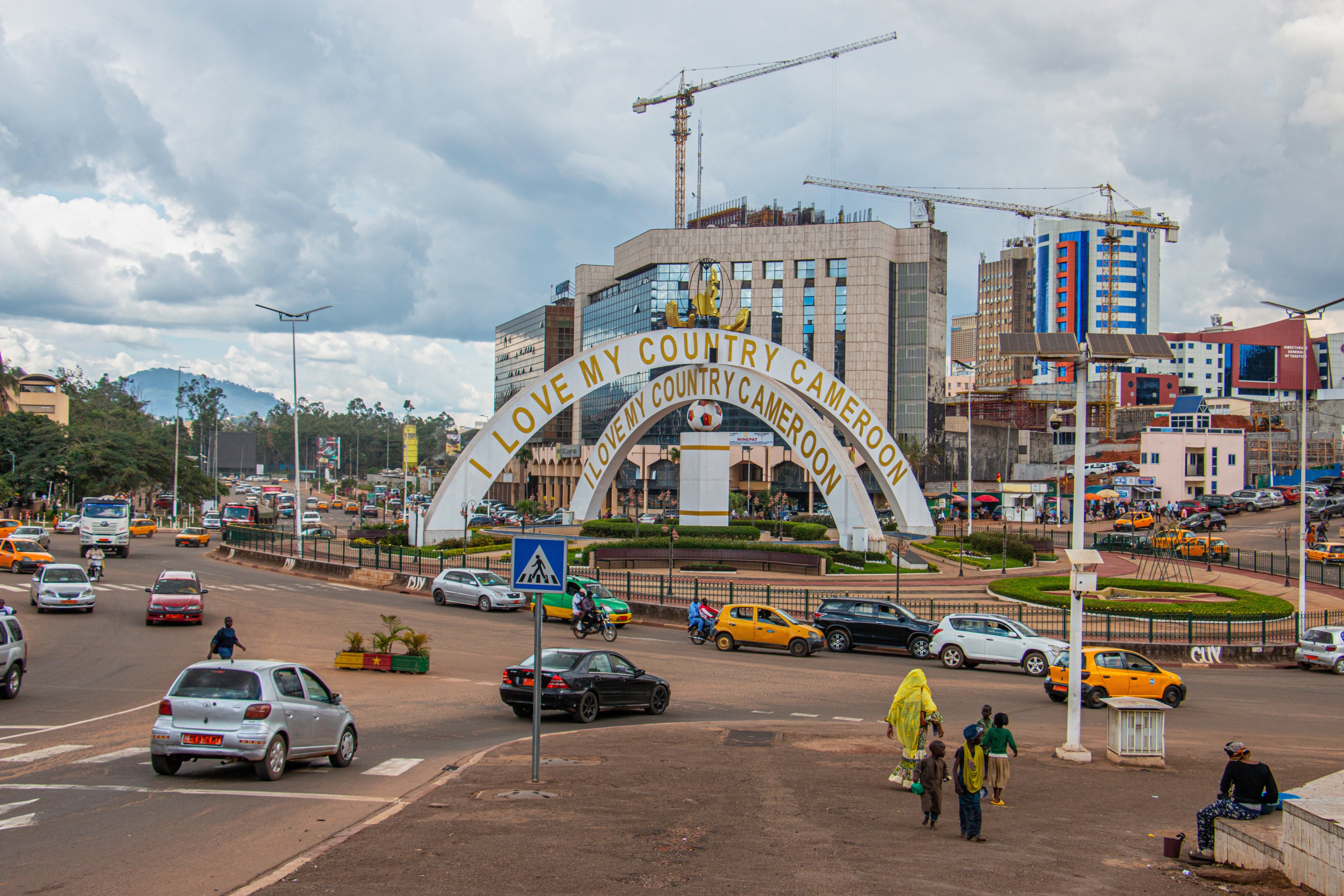 Cars drive through an intersection near a monument in Yaoundé, Cameroon, September12, 2025. 