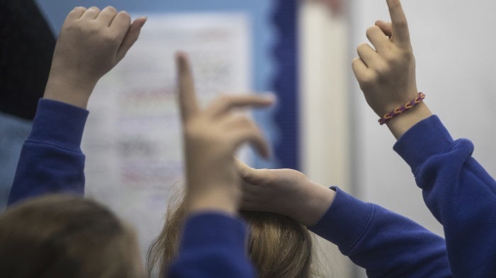 Raised hands in a classroom