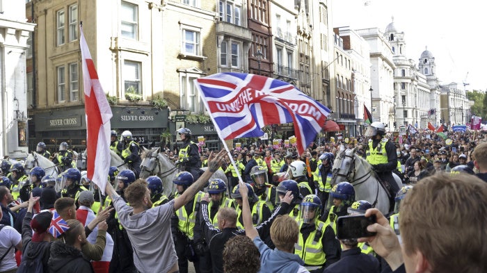 People opposing the housing of asylum seekers (front) confront anti-racism group members (back) with police officers forming a line between them in London, UK, on September 13, 2025. 
