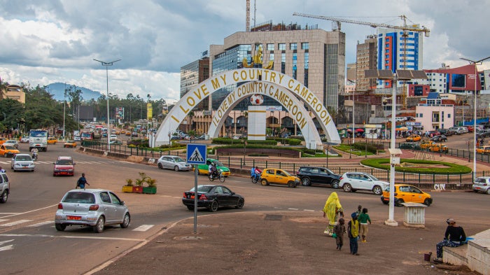 Cars drive through an intersection near a monument in Yaoundé, Cameroon, September12, 2025. 