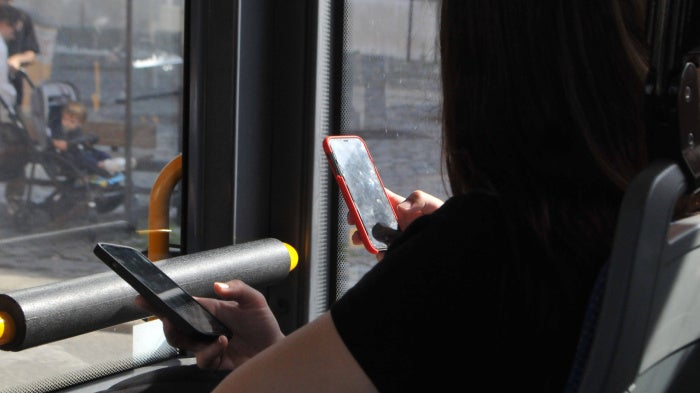 People using their cellphones while in transit, September 2023.
