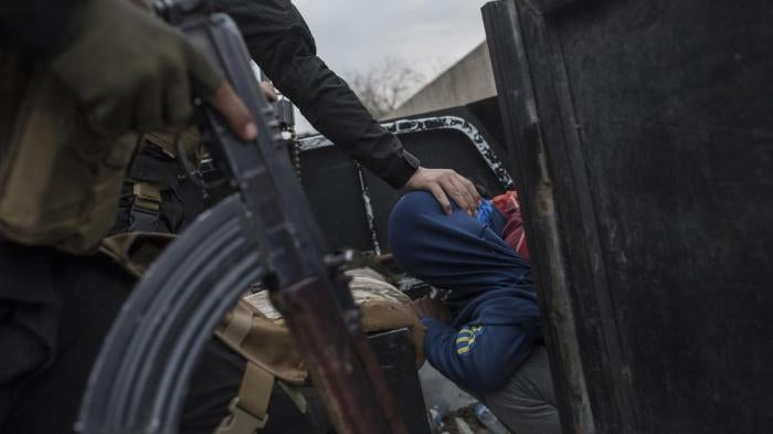 Members of the Iraqi National Security Service arrest a young man they suspect of being affiliated with ISIS in eastern Mosul on March 15, 2017. © 2017 Sam Tarling 