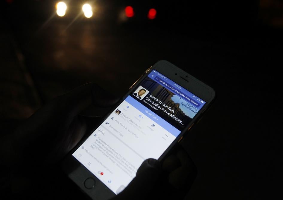 A man views Cambodian Prime Minister Hun Sen's Facebook page on his mobile phone in downtown Phnom Penh, Cambodia.