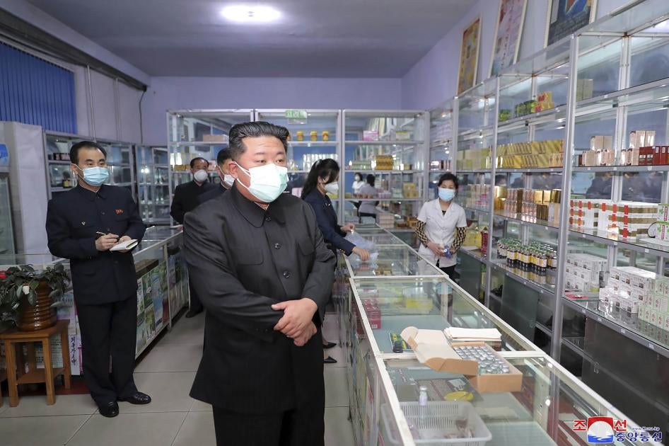 Kim Jong Un wearing a mask, during a visit to a pharmacy