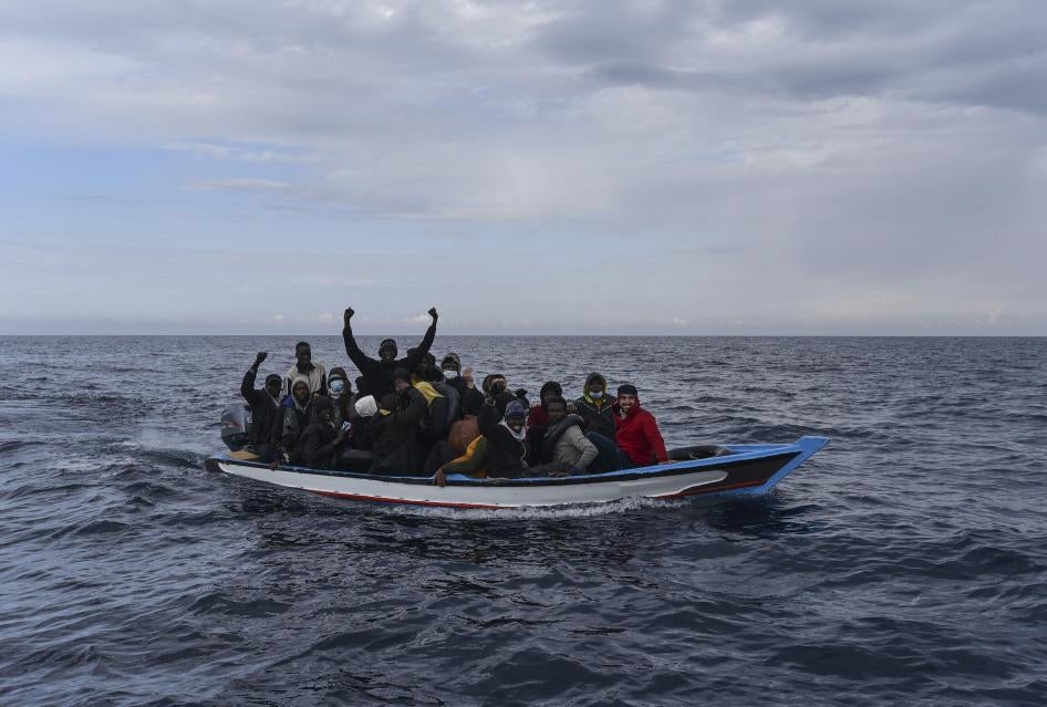 Migrants aboard on a wooden boat in the Mediterranean Sea.