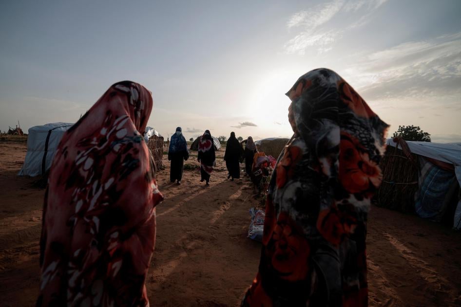  Survivors of sexual violence, who fled the fighting in El Geneina, in Sudan’s Darfur region, outside their makeshift shelters in Adre, Chad, August 1, 2023.&nbsp;© 2023 REUTERS/Zohra Bensemra