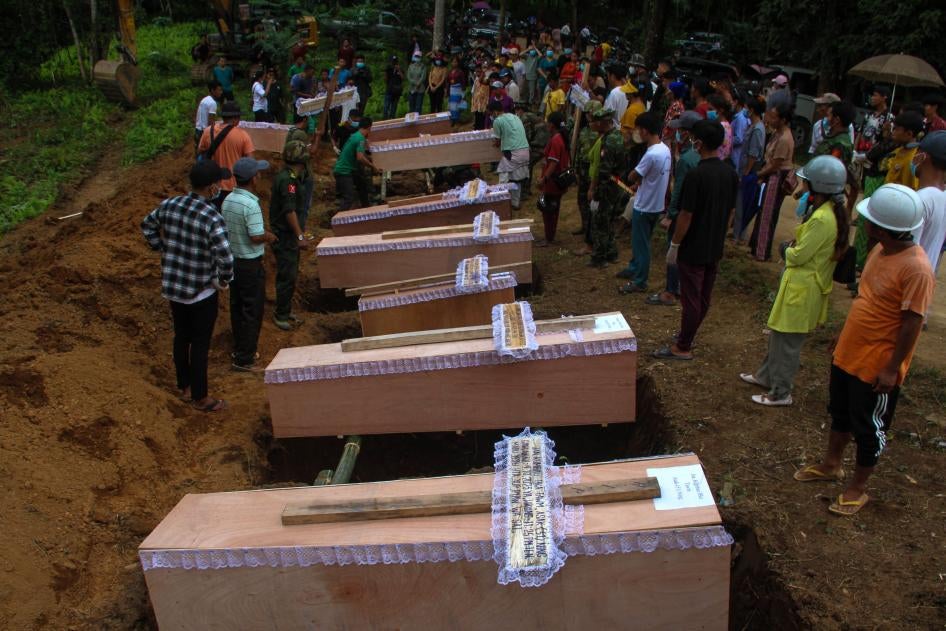 Coffins lined up beside graves at a mass funeral for victims of a Myanmar military strike on a village near Laiza, Myanmar, October 10, 2023.