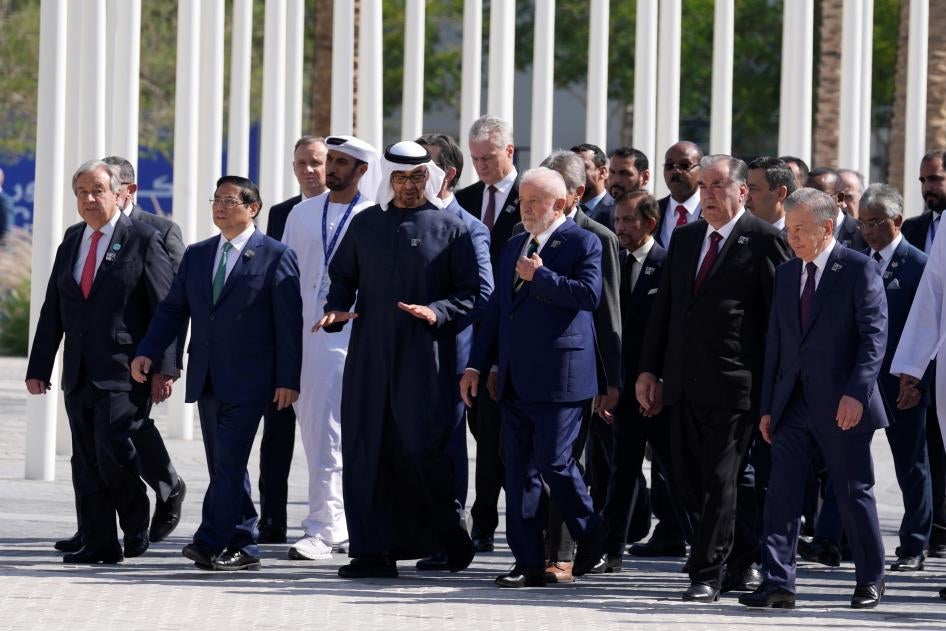 United Nations Secretary-General Antonio Guterres, left, and Brazil President Luiz Inacio Lula da Silva, center, walk with other dignitaries after posing for a group photo at the COP28 U.N. Climate Summit in Dubai, United Arab Emirates, December 1, 2023.