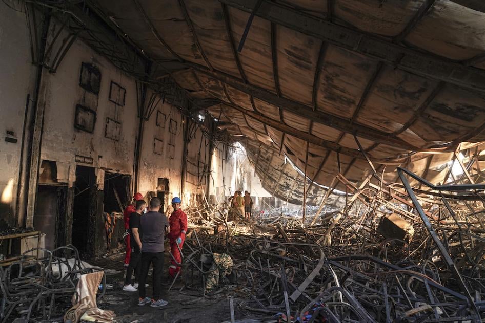 Members of the search team work at a burned down wedding hall after a fatal fire engulfed the hall during a wedding celebration, September 27, 2023. 