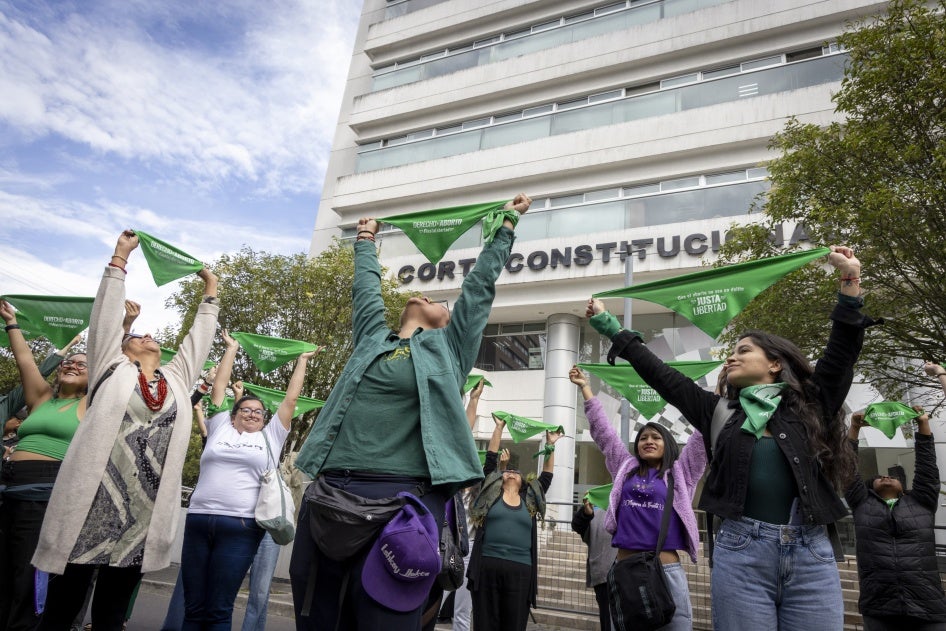 Women from different organizations that are part of the Justa Libertad movement raise green scarves outside the Constitutional Court of Ecuador in Quito, March 19, 2024.