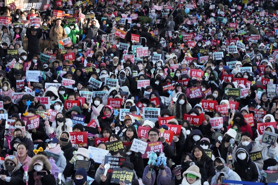 Protesters gather holding banners demanding the impeachment of South Korea's president