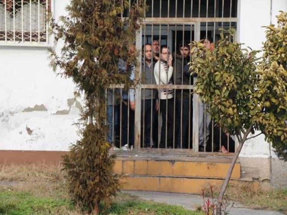 Des hommes derrière le grillage du centre de détention de Gazi Baba, en Macédoine, le 21 janvier 2015.