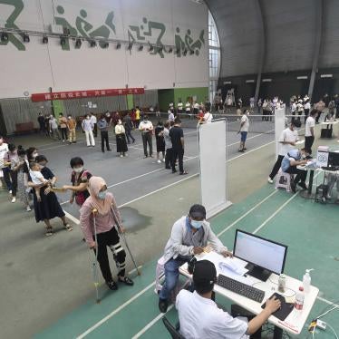 Migrant workers line up for the Covid-19 vaccine at a temporary inoculation site in Wuhan in central China's Hubei province August 23, 2021.
