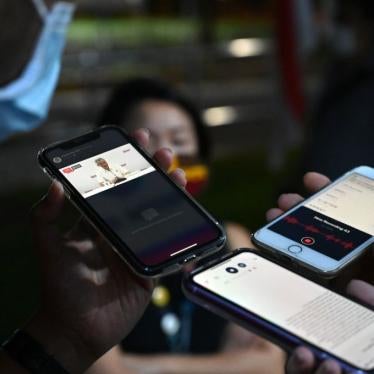 Reporters record a speech by Singapore's Prime Minister Lee Hsien Loong as it is streamed on Facebook live during vote counting in the general election in Singapore, July 11, 2020. 