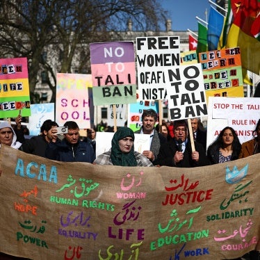 Protesters hold placards at a demonstration calling for women's rights in Afghanistan