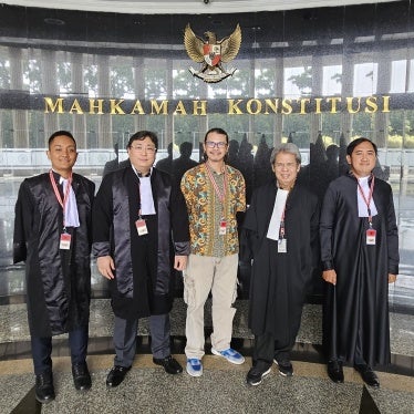 Daniel Tangkilisan (C), the environmentalist who filed the petition, and Todung Mulya Lubis (L-C) and other lawyers from the LSM law firm, at Indonesia’s Constitutional Court in Jakarta, April 29, 2025.