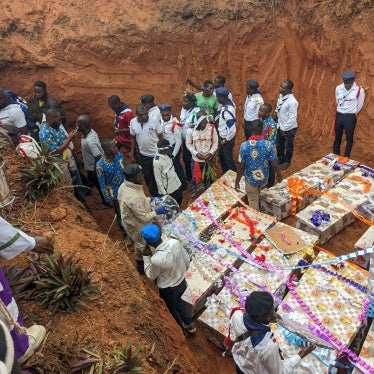 People gathered to bury those killed in an attack