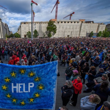 A protester holds up an EU flag with "help" written on it, during a demonstration in Budapest on May 18, 2025 against a bill empowering the government to sanction civil society organizations and media it deems threats to the country's sovereignty.