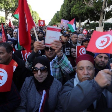 Protestors take part in a rally organized by the Tunisian National Salvation Front opposition coalition to mark the 13th anniversary of the 2011 uprising, in Tunis, January 14, 2024.
