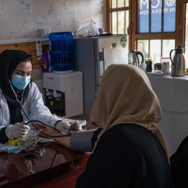 A doctor working with a UN agency examines a woman at a clinic in Herat, Afghanistan, July 5, 2025.