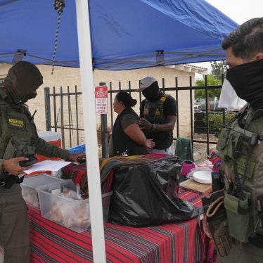 A woman is detained by US Border Patrol agents outside a Home Depot in Los Angeles, California, August 15, 2025.