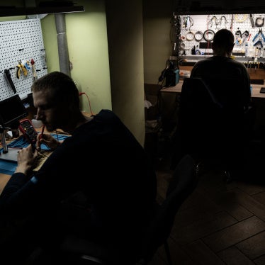 Two Ukrainian soldiers work in a drone workshop in an undisclosed location near the Russian border in the Kursk region, on June 12, 2025.