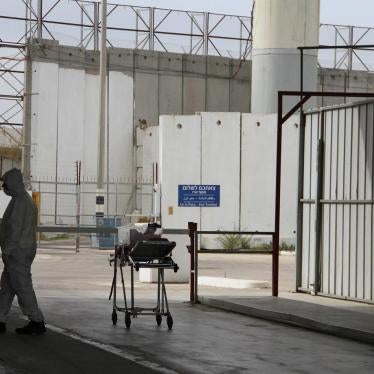 A staff member at the Erez Crossing between Israel and Gaza waits during the transfer of a 6-day-old baby from Gaza to a hospital in the city of Nablus in the occupied West Bank for medical treatment. Israeli authorities approved permits for medical appoi