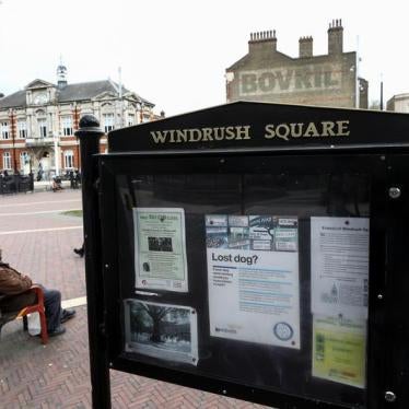 A man sits on a bench next to a sign on Windrush Square in the Brixton district of London, Britain April 16, 2018.