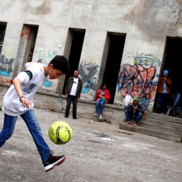 Migrants are seen in front of a dorm destroyed during Bosnian 1992-1995 war, in Bihac, Bosnia and Herzegovina May 11, 2018.