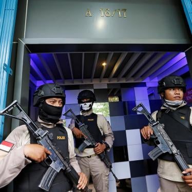 Police officers guard the entry of the T1 night club in Jakarta on October 9, 2017, after they raided it and arrested 10 people for alleged violations of the anti-pornography law. 