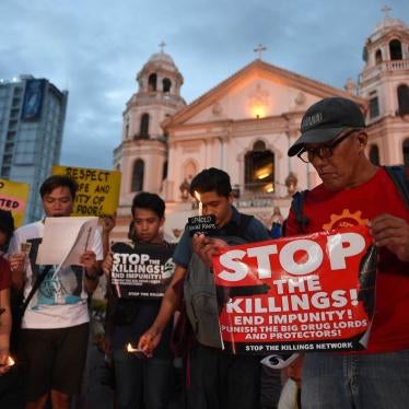 Activists hold a candle light vigil for victims of the extra judicial killings in the drug war of the government in front of a church in Manila on September 16, 2016