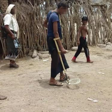 A deminer works with children following him in Zuheiri, a town on the western coast. © 2018 Private