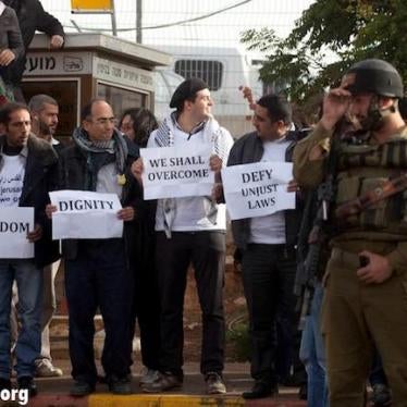 Palestinian activists wait to board an Israeli bus that connects an Israeli settlement in the West Bank to occupied East Jerusalem, to protest discriminatory movement restrictions, on November 15, 2011. 