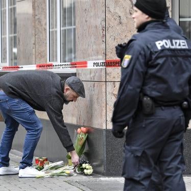 A man places flowers near a shisha bar where several people were killed on Wednesday night in Hanau, Germany, Thursday, Feb. 20, 2020.